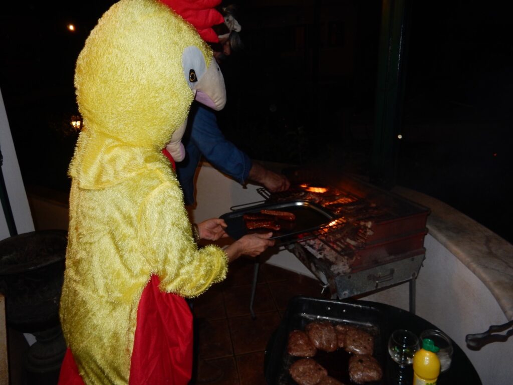 a person in a chicken costume grilling