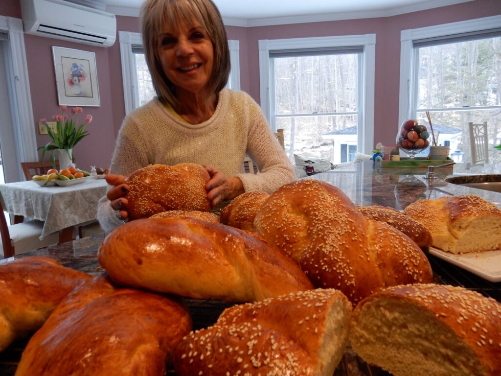 A woman with several loaves of bread in front of her