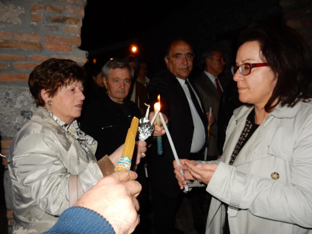 Two women lighting candles