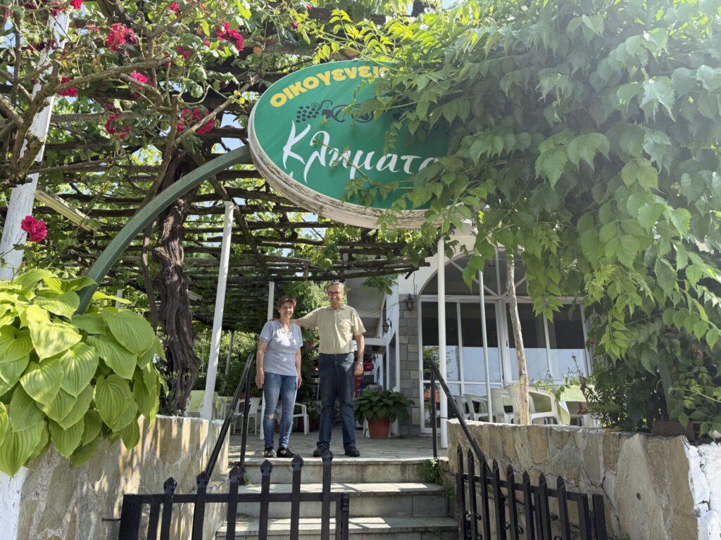 A man and woman on top of steps at restaurant 