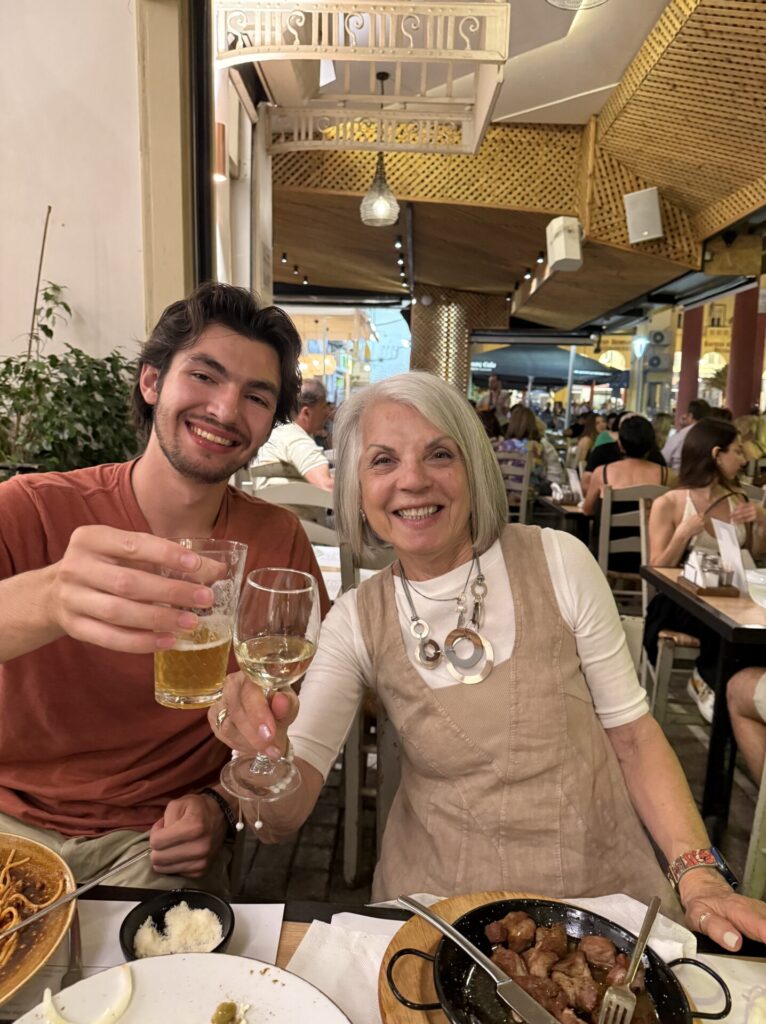 A young man and woman clinging glasses at a restaurant 