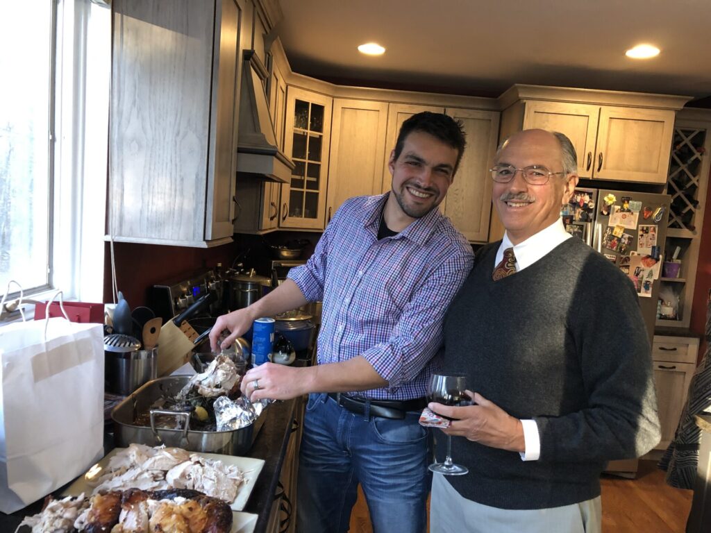 Two men with a cooked turkey