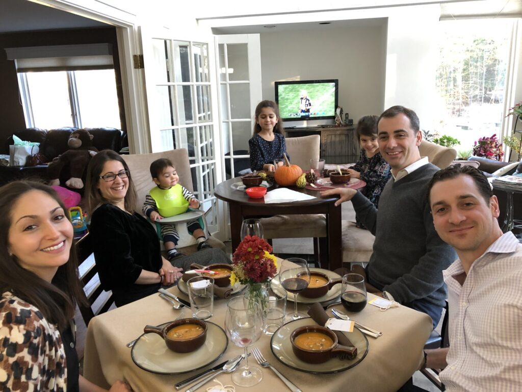 Adults and children at a dinner table