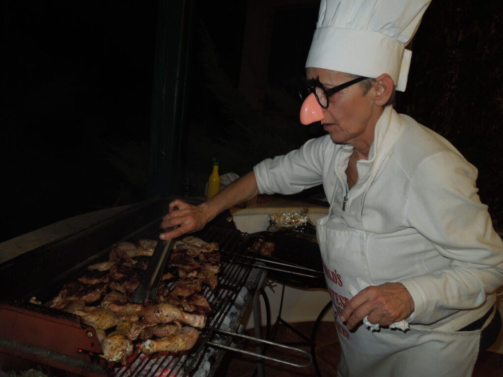A person in chef’s costume grilling