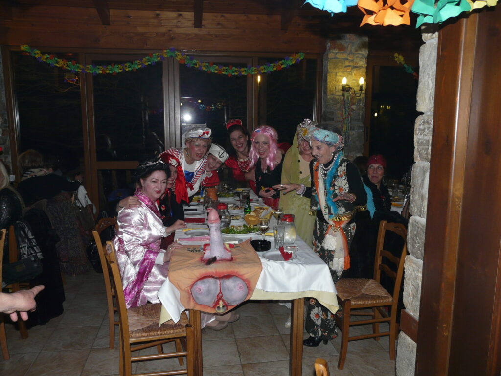 People in costume for Greek Carnavali Sitting at a table