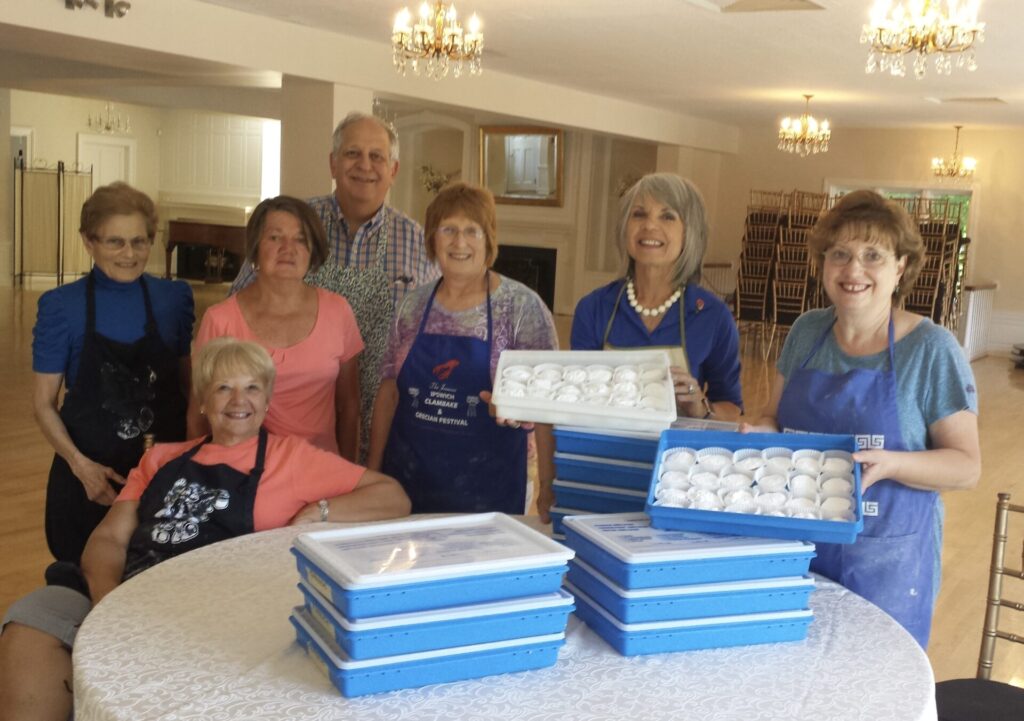 Women and a man displaying Greek cookies